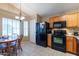 Bright kitchen featuring tile floors, a breakfast table, and black appliances at 276 E Senna Way, San Tan Valley, AZ 85143