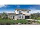 Charming two-story home featuring a stone facade, well-manicured lawn, and a two-car garage at 3273 W Storm Cloud St, San Tan Valley, AZ 85144
