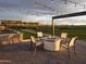 Inviting outdoor fire pit with comfortable seating and charming string lights for memorable evenings at 3294 W Storm Cloud St, San Tan Valley, AZ 85144