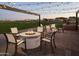 Cozy outdoor fire pit area with chairs, perfect for gatherings, with string lights and neighborhood in the background at 3294 W Storm Cloud St, San Tan Valley, AZ 85144