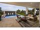An outdoor living space showcasing a modern pool, water feature, and ample seating on the patio at 3307 W Storm Cloud St, San Tan Valley, AZ 85144