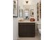 Modern bathroom with a floating vanity, multiple mirrors, and unique wooden decor at 3307 W Storm Cloud St, San Tan Valley, AZ 85144
