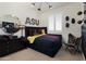 Sport themed bedroom with a stylish black accent wall, playful decor, and comfortable seating at 3307 W Storm Cloud St, San Tan Valley, AZ 85144