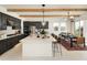 Modern kitchen featuring dark cabinetry, a center island with seating, and stainless steel appliances at 3307 W Storm Cloud St, San Tan Valley, AZ 85144