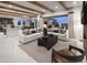 Open-concept living room featuring neutral tones, wood beam ceilings, and access to the backyard at 3307 W Storm Cloud St, San Tan Valley, AZ 85144