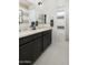 Spacious bathroom featuring double sinks, dark cabinets, and a tiled shower/tub combo for modern living at 3391 W Sunstone Dr, San Tan Valley, AZ 85144