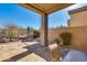 Inviting covered patio with desert landscape, stone ground cover, and mountain views at 34435 N 68Th Way, Scottsdale, AZ 85262