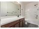 Neutral bathroom with wooden vanity, shower and tiled backsplash at 3595 E Desert Moon Trl, San Tan Valley, AZ 85143