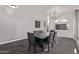 A dining room features a wood table with six chairs, and neutral walls with white trim at 3595 E Desert Moon Trl, San Tan Valley, AZ 85143