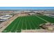 Dramatic aerial view showing fields of green crops and a mix of commercial and industrial buildings at 4100 S Pinelake Way # 143, Chandler, AZ 85249