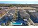 Wide aerial shot of the residential area, capturing the swimming pool, homes, and nearby amenities at 4100 S Pinelake Way # 143, Chandler, AZ 85249