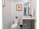 Powder bathroom with a decorative mirror, gray vanity, and a tiled floor at 4100 S Pinelake Way # 143, Chandler, AZ 85249