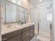 Bathroom featuring a double sink and a glass enclosed shower at 4100 S Pinelake Way # 143, Chandler, AZ 85249