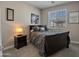 Cozy bedroom with a comfortable bed, nightstand, and a window with blinds at 4100 S Pinelake Way # 143, Chandler, AZ 85249