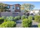 Well-maintained Pinalake Place community entrance with desert landscaping and a stone accent wall on a two-story home at 4100 S Pinelake Way # 143, Chandler, AZ 85249