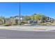 Welcoming community entrance with stone accents, lush landscaping, and clear blue skies at 4100 S Pinelake Way # 143, Chandler, AZ 85249