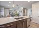 Modern kitchen features a large island with a stainless steel sink and stylish pendant lighting at 4100 S Pinelake Way # 143, Chandler, AZ 85249