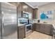 Well-equipped kitchen with stainless steel appliances, dark cabinetry, and white subway tile backsplash at 4100 S Pinelake Way # 143, Chandler, AZ 85249