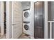 Convenient laundry room with stacked washer and dryer and custom cabinets for storage solutions at 4100 S Pinelake Way # 143, Chandler, AZ 85249