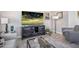 A spacious living room features a large TV, stylish decor, and comfortable seating at 4100 S Pinelake Way # 143, Chandler, AZ 85249