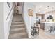 Carpeted staircase with white banisters leads to the upper level of the home at 4100 S Pinelake Way # 143, Chandler, AZ 85249