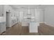 Bright kitchen features white cabinets, modern appliances, a marble countertop island and wood floors at 4210 E Desert Vista Trl, Cave Creek, AZ 85331
