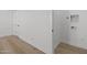 Bright laundry room with wood floors, washer/dryer hookups, and white walls at 4210 E Desert Vista Trl, Cave Creek, AZ 85331