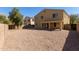 Large gravel backyard with view of the home's rear elevation; great for outdoor activities and potential customization at 43608 W Kristal Ln, Maricopa, AZ 85138