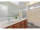 Bathroom boasts dual sinks, a large mirror and a shower-tub combination at 43608 W Kristal Ln, Maricopa, AZ 85138