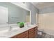Bathroom features dual sinks, a large mirror and a shower-tub combination at 43608 W Kristal Ln, Maricopa, AZ 85138