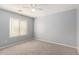 Cozy bedroom with neutral walls, carpet flooring and large window with blinds at 43608 W Kristal Ln, Maricopa, AZ 85138