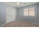 Bedroom boasts carpet flooring, a ceiling fan, and a roomy closet at 43608 W Kristal Ln, Maricopa, AZ 85138
