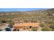 Expansive desert property featuring a tile roofed home and a sparkling pool with red umbrellas at 43638 N 22Nd St, New River, AZ 85087