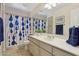 Neutral toned bathroom with tiled floors and a large mirror at 43638 N 22Nd St, New River, AZ 85087