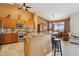 Well-lit kitchen with granite countertops, a large island, stainless steel appliances, and tile flooring at 43638 N 22Nd St, New River, AZ 85087