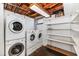 A basement laundry area with washer, dryer, and shelving at 5222 S 5Th St, Phoenix, AZ 85040