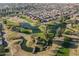 Expansive aerial view of a community with lush golf courses, serene ponds, and neatly arranged residential areas at 54 Leisure World --, Mesa, AZ 85206