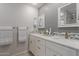 Bathroom featuring a dual vanity, decorative mirror, and modern fixtures at 54 Leisure World --, Mesa, AZ 85206