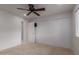 Bright bedroom features a closet, a ceiling fan, and access to other rooms at 54 Leisure World --, Mesa, AZ 85206