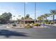 Well-maintained community entrance with desert landscaping, palm trees, and clear signage, ensuring safety at 54 Leisure World --, Mesa, AZ 85206