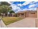 A single-story home with well-maintained landscaping, a one car garage, and a paved driveway at 54 Leisure World --, Mesa, AZ 85206