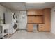Garage space featuring laundry, workbench, storage cabinets, pegboard, desk space, and access to the exterior at 54 Leisure World --, Mesa, AZ 85206