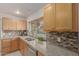 Beautiful kitchen featuring stainless steel dishwasher, wooden cabinets, and granite countertops at 54 Leisure World --, Mesa, AZ 85206
