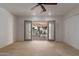 Light-filled living room boasts a ceiling fan and French doors to a charming patio at 54 Leisure World --, Mesa, AZ 85206