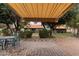Paver patio with retractable awning and view of lush backyard landscaping at 54 Leisure World --, Mesa, AZ 85206