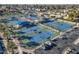Aerial view of several well-maintained tennis courts with parking and landscaping at 54 Leisure World --, Mesa, AZ 85206
