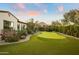 Landscaped backyard with a putting green and desert plants at 6640 E Kasba Cir, Paradise Valley, AZ 85253