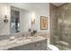 Modern bathroom with a granite vanity top, framed mirror, and glass shower enclosure at 6640 E Kasba Cir, Paradise Valley, AZ 85253