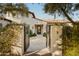 Inviting entryway featuring a decorative iron door, with stone walkway and desert landscaping at 6640 E Kasba Cir, Paradise Valley, AZ 85253