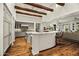 Spacious kitchen features wooden beams, an island, marble counters, and views to the living space at 6640 E Kasba Cir, Paradise Valley, AZ 85253